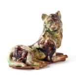 An 18th century Whieldon type reclining lion figure, 8cms high.