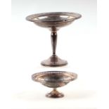 A George V silver shallow pedestal bowl with pierced rim, 96g, 13cms diameter; together with an