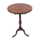 A 19th century mahogany tripod table on a turned column terminating in a tripod base with slipper