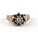 A 9ct gold diamond and sapphire cluster ring. Approx. UK size S. 3.5g