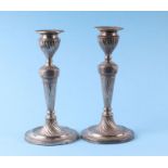 A pair of late Victorian silver candlesticks in the Adam taste with spiral twist columns,
