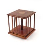 An Edwardian inlaid mahogany table top revolving bookcase, 28cms wide.