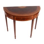 An inlaid figured mahogany demi lune tea table on square tapering legs. 92cm wide