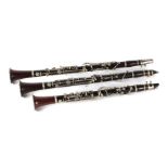 A set of three Jerome Thibouville Lamy clarinets in the keys of B, A and C, in a mahogany case.