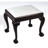 A George III style mahogany footstool with acanthus leaf carved cabriole legs terminating in
