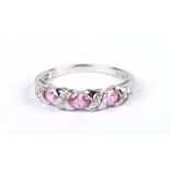 A 9ct white gold ring set with pale pink stones interspersed with diamonds, approx UK size 'L', 2g.