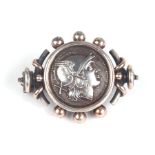 A Victorian silver and gold brooch inset with a silver Roman / Greek coin.Condition ReportTotal