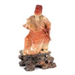 A large Chinese carved soapstone figure depicting Guan Yu, God of War, seated and holding a