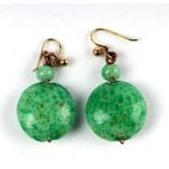 A pair of 9ct gold jade like drop earrings.