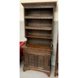 A narrow oak hall dresser with three section open