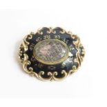 An ornate Victorian mourning brooch, the central o
