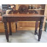 A Victorian carved oak side table, with a carved b
