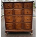A 20th century oak chest of drawers, set with thre