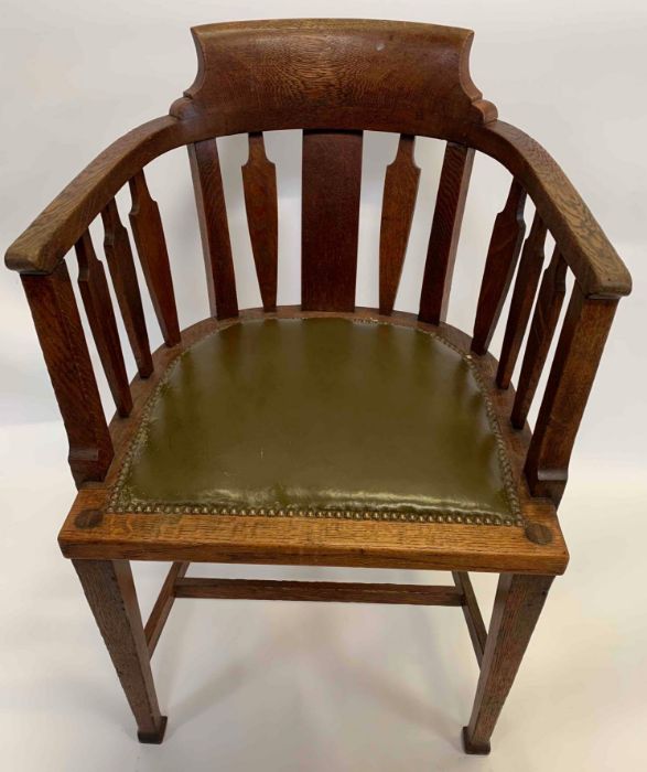 An oak Arts and Crafts smokers chair, with a gree