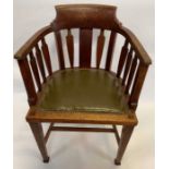 An oak Arts and Crafts smokers chair, with a gree