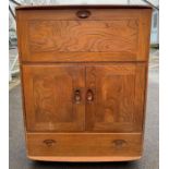 An Ercol cabinet and bureau, model number 430, wi