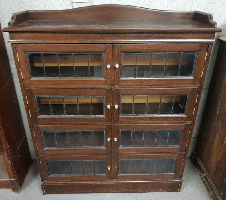 An four section oak bookcase, with four glass and