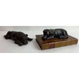 A bronzed figure of a labrador, lying on a base in