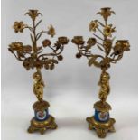A pair of gilt metal candlesticks, with a standing