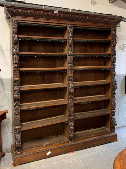 A large Victorian carved oak double bookcase, with