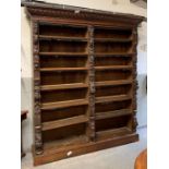 A large Victorian carved oak double bookcase, with