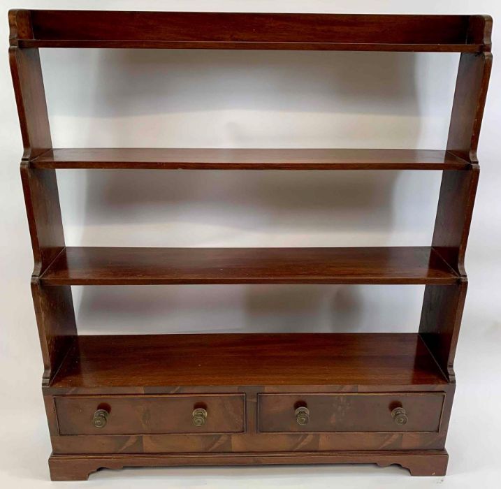 A mahogany free standing waterfall bookcase, set w