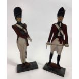 A pair of wooden standing models of soldiers, "Tra