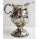 An 18th century style silver repousse decorated cr