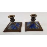 A pair of lapis lazuli and brass candlesticks, sta