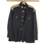 A collection of military uniforms to include a bla