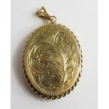 A 9ct gold oval locket with rope twist edge do