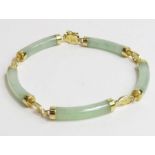 A 14ct gold bracelet set with five shaped jade