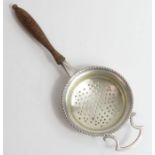 A 19th century style silver tea strainer with pier