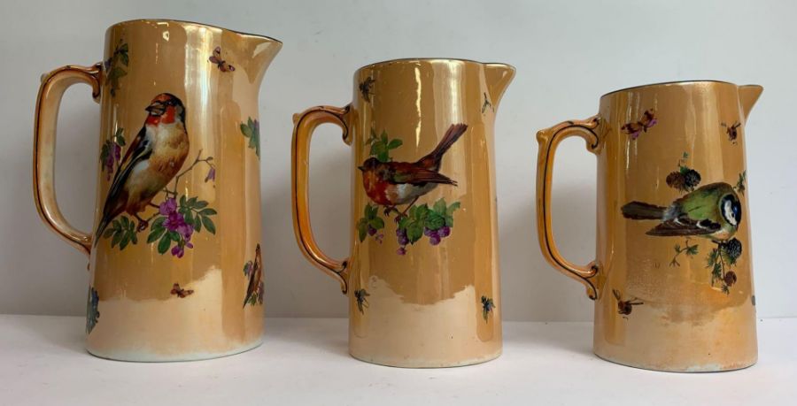 A set of three Edwardian lustre graduated jugs, de