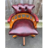 A Victorian style red leather upholstered swivel c