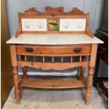 An Edwardian pine washstand with tiled back and ma