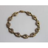 A 9ct gold link bracelet, the links in the shaped