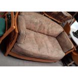 An Ercol settee with light wood stick frame and or