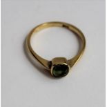 A single stone peridot ring, the square stone appr