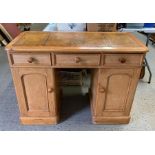 A 20th century pine pedestal desk with inset leath