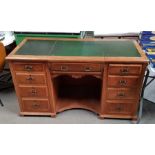 An Edwardian light oak pedestal desk with leather