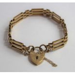 A 9ct gold three bar gate bracelet, with engraved