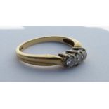 An 18ct gold graduated diamond three stone ring, e