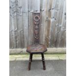 An early 20th century carved oak spinning stool