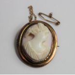 An oval pink shell cameo brooch, the cameo carved