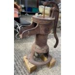 Cast iron water pump on a wooden base