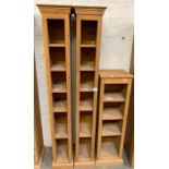 Pair of tall pine shelving units along with 1 othe