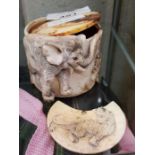 Heavily carved bone pot decorated with wild animal