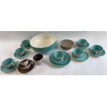 A collection of Poole pottery two tone cups and sa