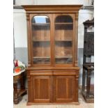 A Victorian pitch pine two section bookcase, with